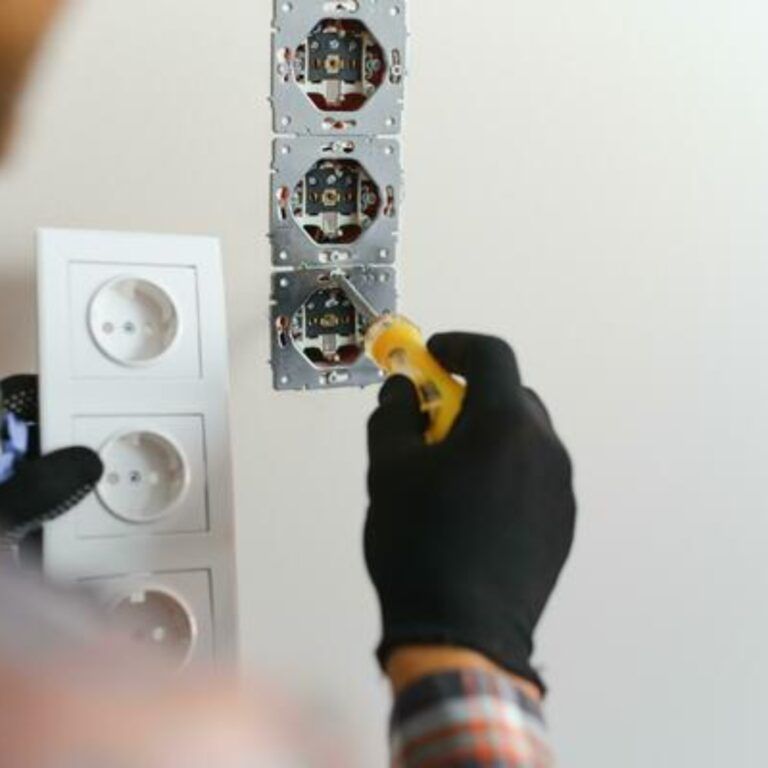 electrician-installs-decorative-frame-on-electric-and-tv-sockets-photo